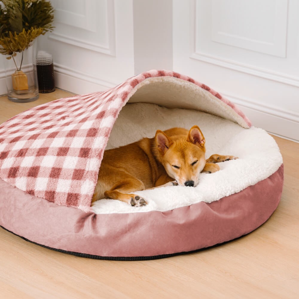 Cozy dog and cat bed with soft interior and a plaid cover for ultimate pet comfort