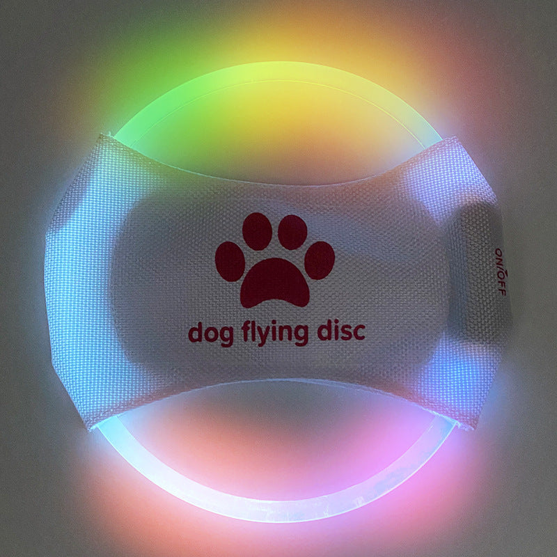 Colorful LED dog flying disc with a paw print design for evening playtime and outdoor fun
