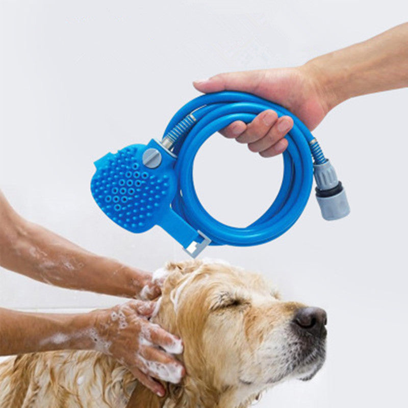 Pet bathing tool massager in use with a hand washing a dog, featuring a blue hose and massaging bristles