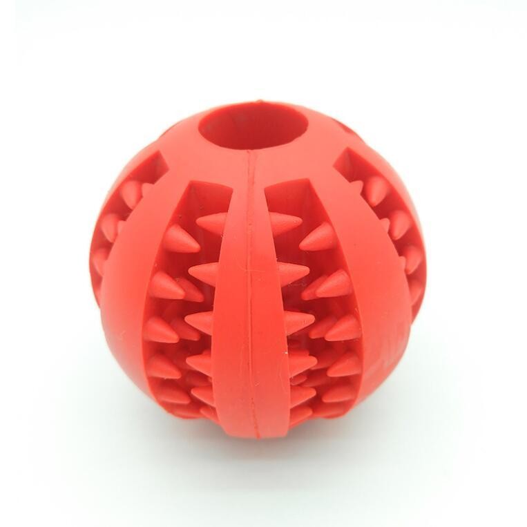Bright red rubber dog ball toy featuring textured spikes for enhanced playtime fun
