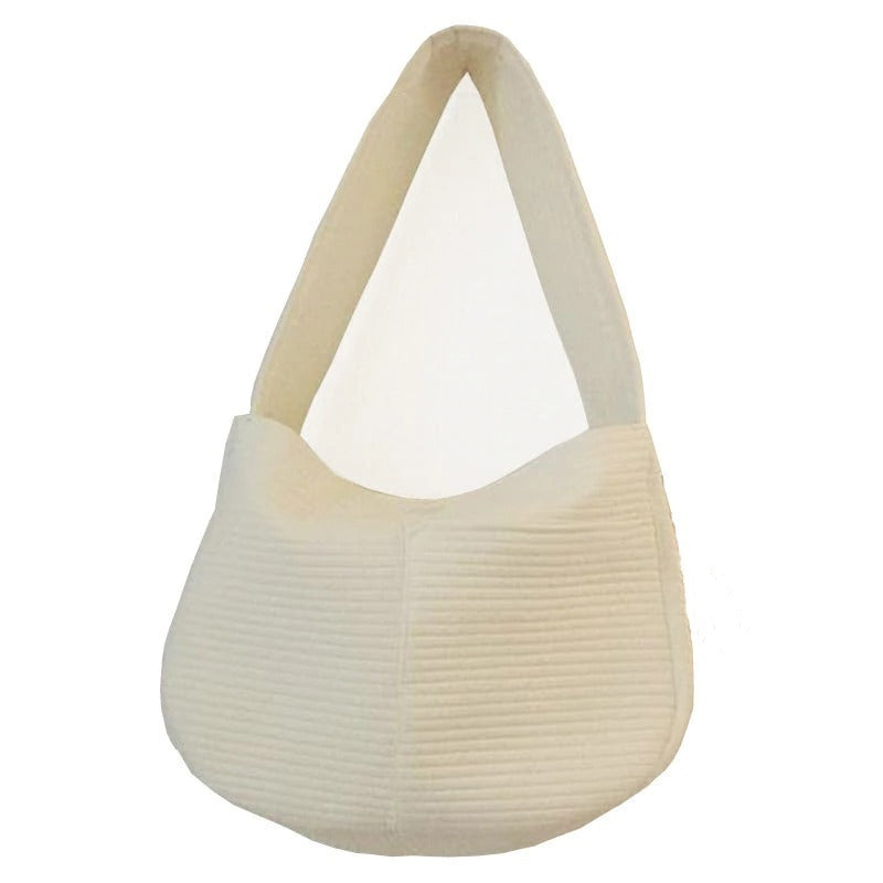 Soft cushion dog travel bag in cream color with a comfortable design for pet owners on the go