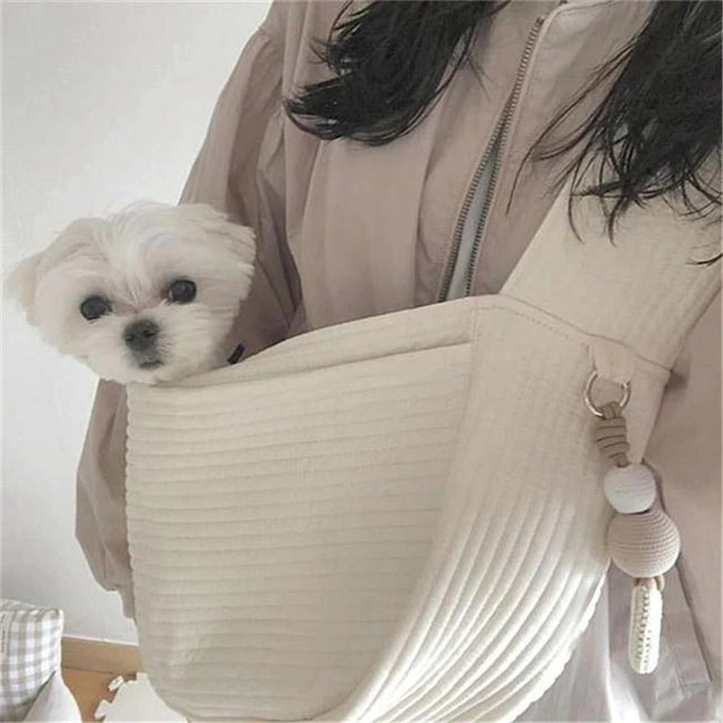 Soft cushion dog travel bag in cream color with small dog comfortably nestled inside