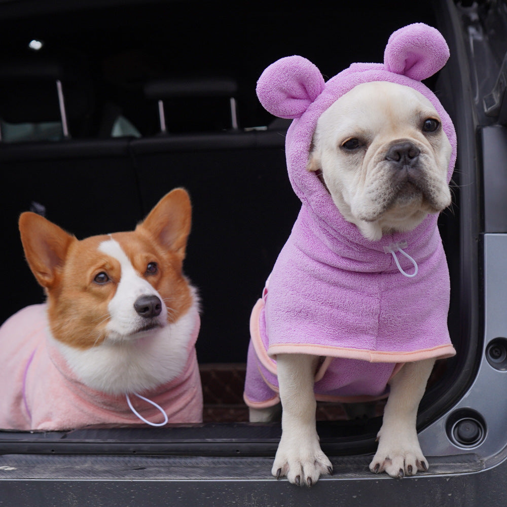 Two dogs wearing pink super absorbent dog towel in a car for dry and cozy post-bath comfort