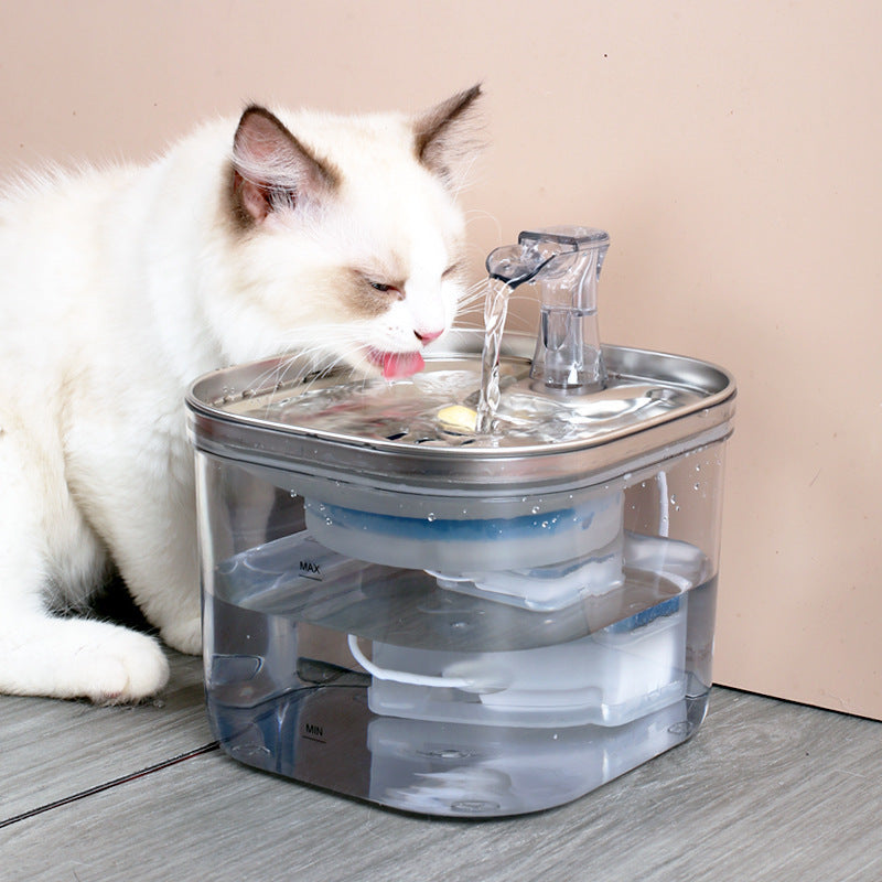 Cat drinking from an automatic pet water fountain with a sleek design for fresh water supply