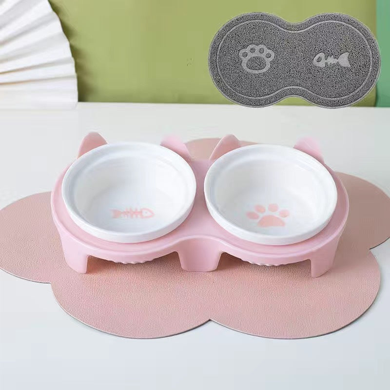 Ceramic cat bowl set with pink silicone mat featuring fish and paw print designs for pets
