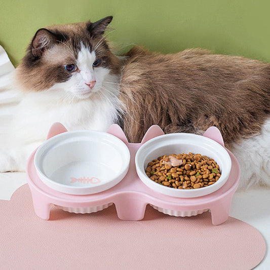 Ceramic cat bowl set with two compartments for food and water, featuring a cute design for pets