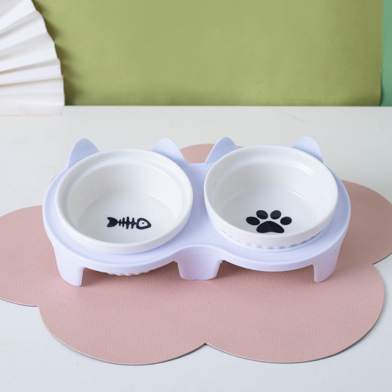 Ceramic cat bowl set with cute fish and paw designs on a white base for pet feeding