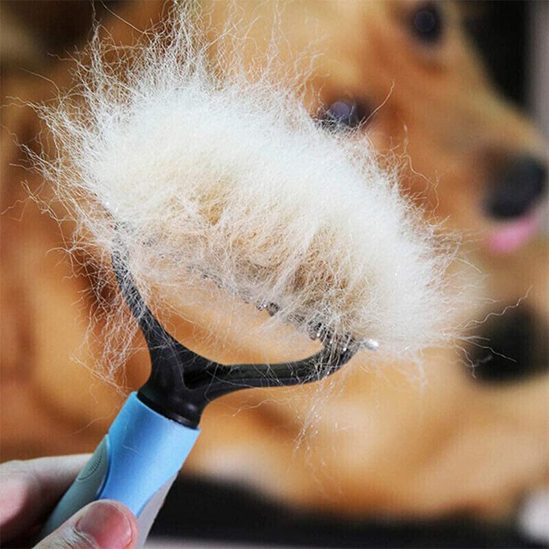 Double sided pet deshedding tool removing loose fur with a dog in the background