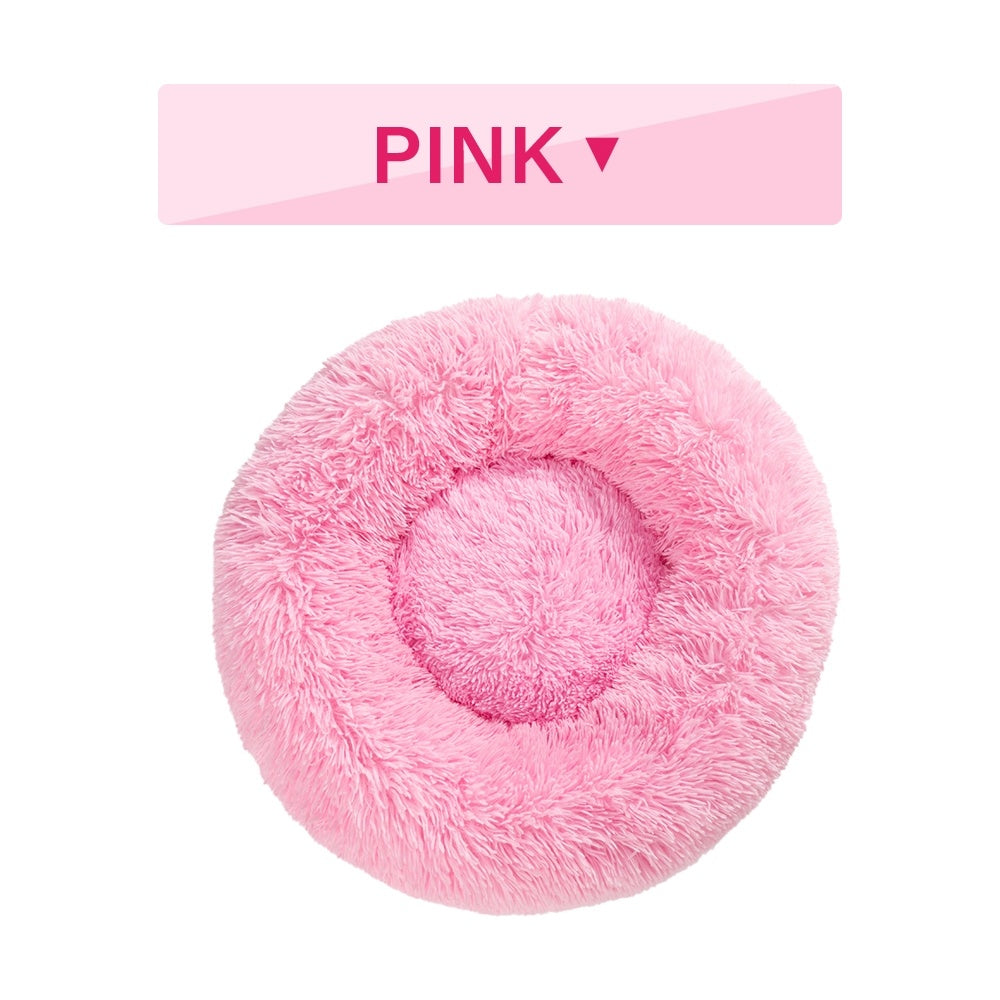 Fluffy donut dog bed in soft pink, perfect for keeping pets cozy and comfortable