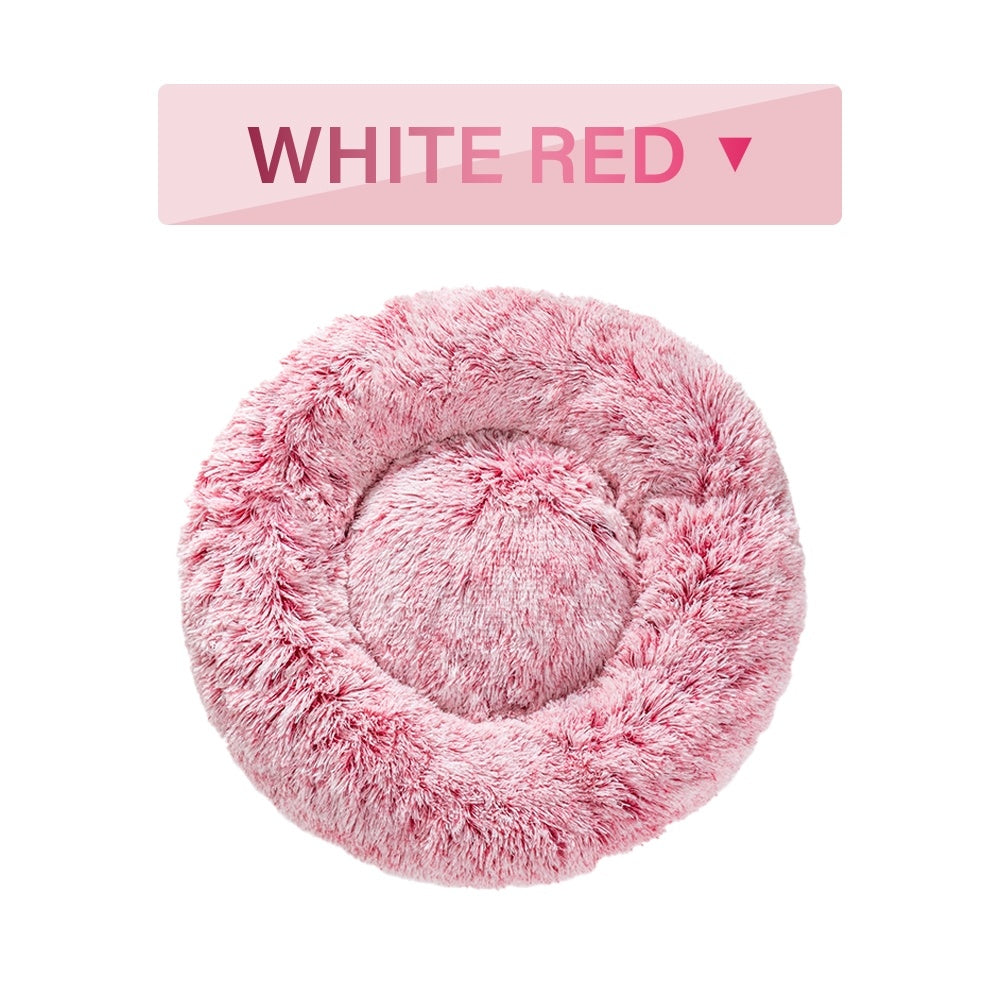 Fluffy donut dog bed in pink, ideal for small pets seeking comfort and warmth