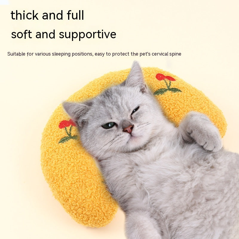 Cat resting on a yellow half-donut neck pillow, designed for comfort and stress relief.
